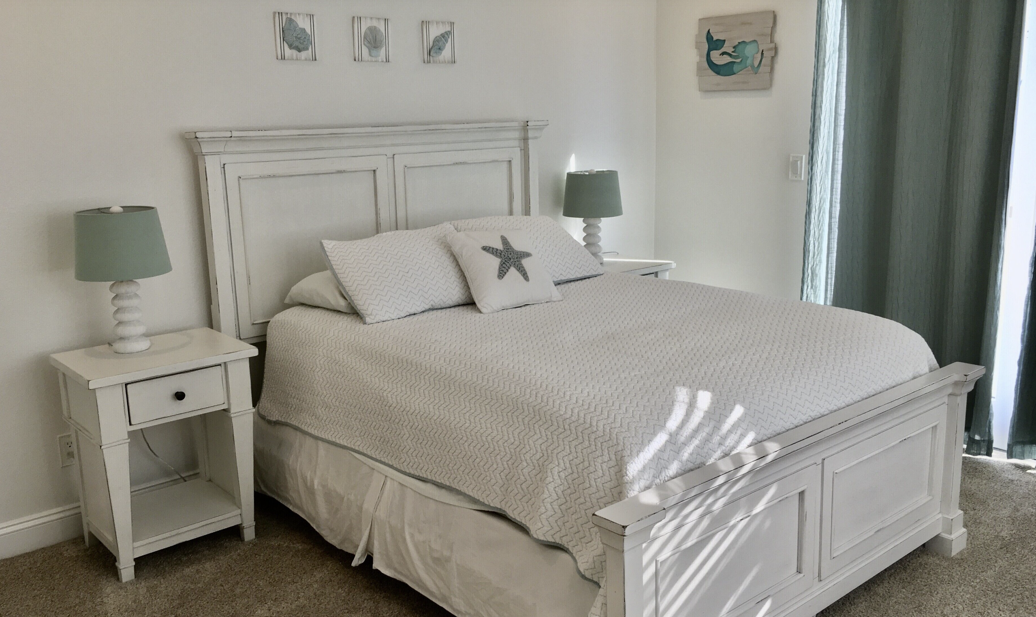 Bedroom 2 with queen bed and slider doors to patio